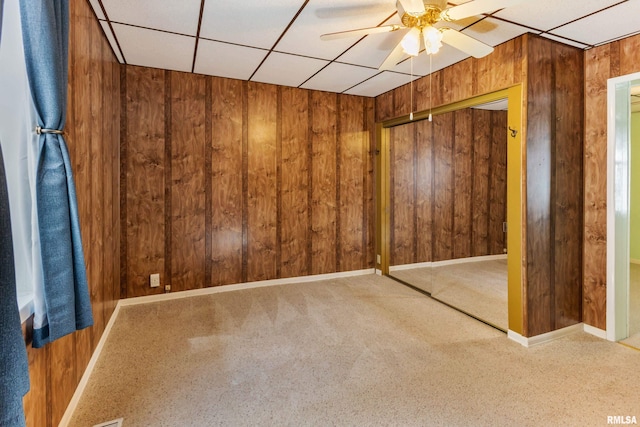 925 Payson Ave, Quincy, IL 62301 - carpeted spare room featuring a ceiling fan, wooden walls, and a drop ceiling