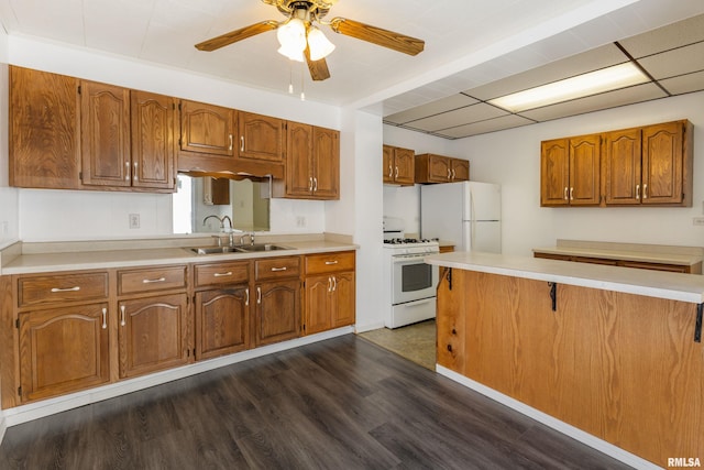 925 Payson Ave, Quincy, IL 62301 - kitchen with white appliances, brown cabinets, dark wood-style floors, and light countertops
