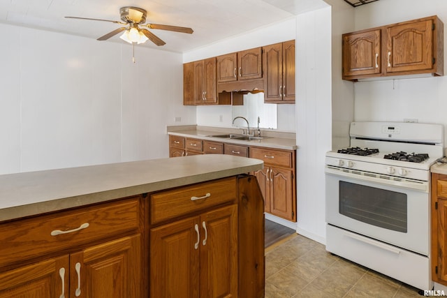 925 Payson Ave, Quincy, IL 62301 - kitchen featuring white range with gas cooktop, ceiling fan, and brown cabinetry