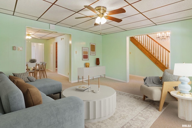 925 Payson Ave, Quincy, IL 62301 - carpeted living area featuring a paneled ceiling, ceiling fan, stairway, and a chandelier