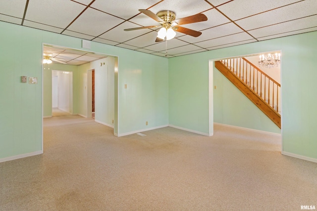 925 Payson Ave, Quincy, IL 62301 - carpeted spare room with stairway, a paneled ceiling, a ceiling fan, and a chandelier