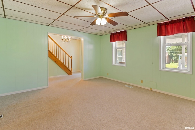 925 Payson Ave, Quincy, IL 62301 - spare room with carpet flooring, a paneled ceiling, a ceiling fan, a chandelier, and stairs