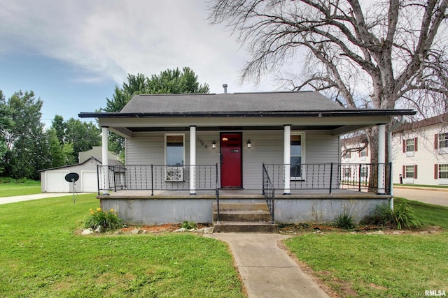 1940 Mulholland St, Nauvoo, IL 62354 - bungalow-style house featuring a porch, a front yard, a detached garage, and a shingled roof