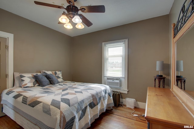 1940 Mulholland St, Nauvoo, IL 62354 - bedroom with wood finished floors, cooling unit, and a ceiling fan