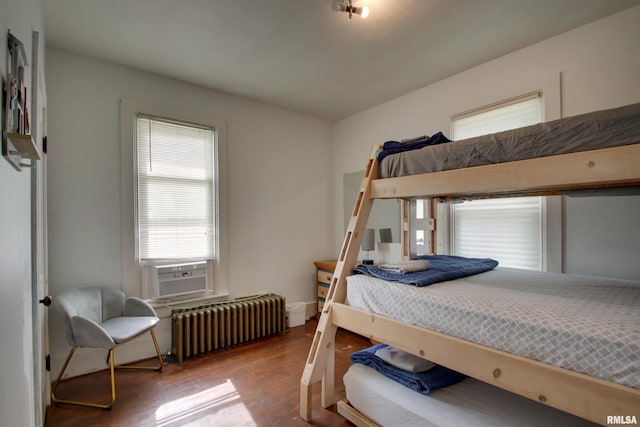 1940 Mulholland St, Nauvoo, IL 62354 - bedroom with radiator heating unit, wood finished floors, and cooling unit