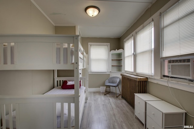 1940 Mulholland St, Nauvoo, IL 62354 - bedroom featuring radiator, light wood-style flooring, ornamental molding, and cooling unit