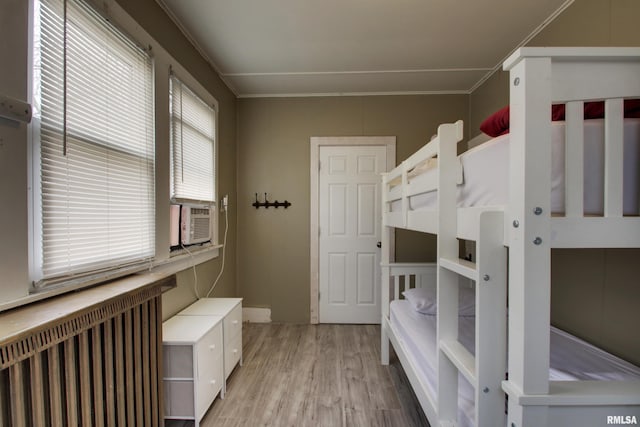 1940 Mulholland St, Nauvoo, IL 62354 - unfurnished bedroom featuring radiator, light wood-style flooring, and cooling unit