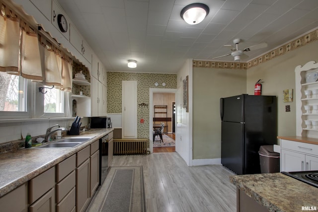 1940 Mulholland St, Nauvoo, IL 62354 - kitchen featuring freestanding refrigerator, dishwashing machine, ceiling fan, light wood-style floors, and wallpapered walls