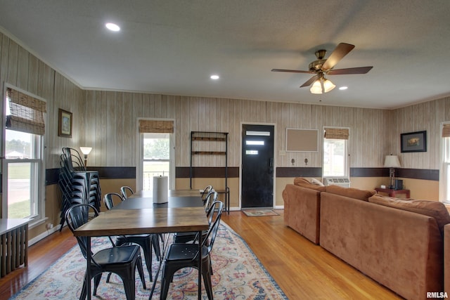 1940 Mulholland St, Nauvoo, IL 62354 - dining space with healthy amount of natural light, ceiling fan, wallpapered walls, light wood-type flooring, and ornamental molding
