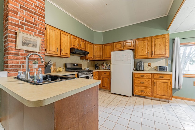 114 N Spring St, Mount Pulaski, IL 62548 - kitchen featuring freestanding refrigerator, stainless steel range with gas cooktop, under cabinet range hood, ornamental molding, and light countertops