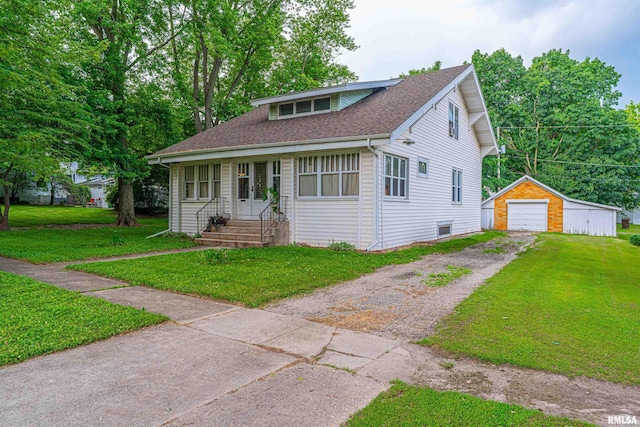 114 N Spring St, Mount Pulaski, IL 62548 - view of front of property featuring driveway, a front yard, a shingled roof, an outbuilding, and a detached garage