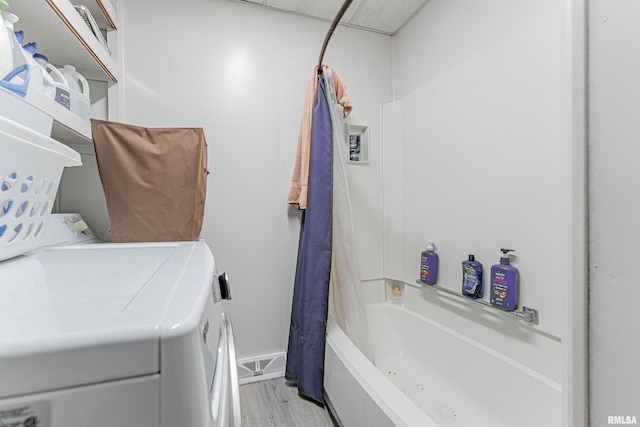 114 N Spring St, Mount Pulaski, IL 62548 - full bathroom with independent washer and dryer, wood finished floors, shower / tub combo, and vanity
