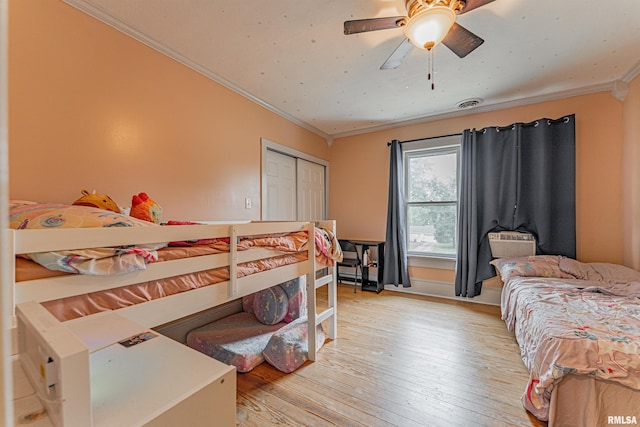 114 N Spring St, Mount Pulaski, IL 62548 - bedroom with ornamental molding, light wood-style flooring, a closet, and ceiling fan