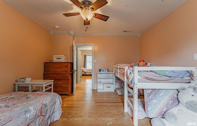 114 N Spring St, Mount Pulaski, IL 62548 - bedroom with ornamental molding, light wood-type flooring, and a ceiling fan