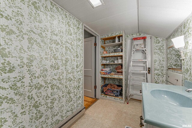 114 N Spring St, Mount Pulaski, IL 62548 - bathroom featuring wallpapered walls, vaulted ceiling, vanity, and a baseboard heating unit