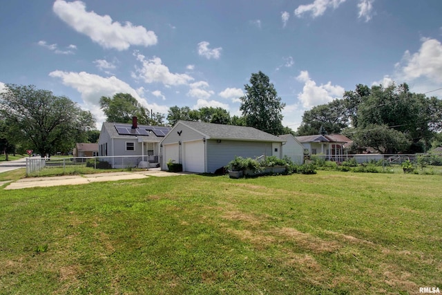1421 N 13th St, Quincy, IL 62301 - back of house with roof mounted solar panels, a garage, and driveway