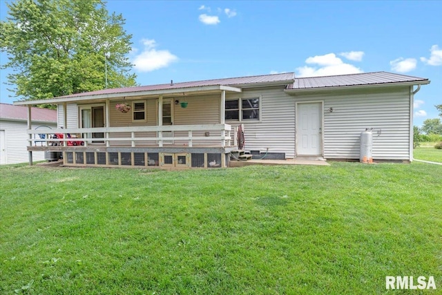 19581 Finney Rd, Girard, IL 62640 - back of property with a yard, a metal roof, and a deck
