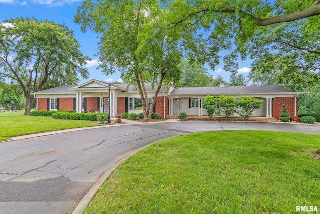 880 Old Tipton School Rd, Sherman, IL 62684 - view of front of house with brick siding, curved driveway, a front yard, and a chimney