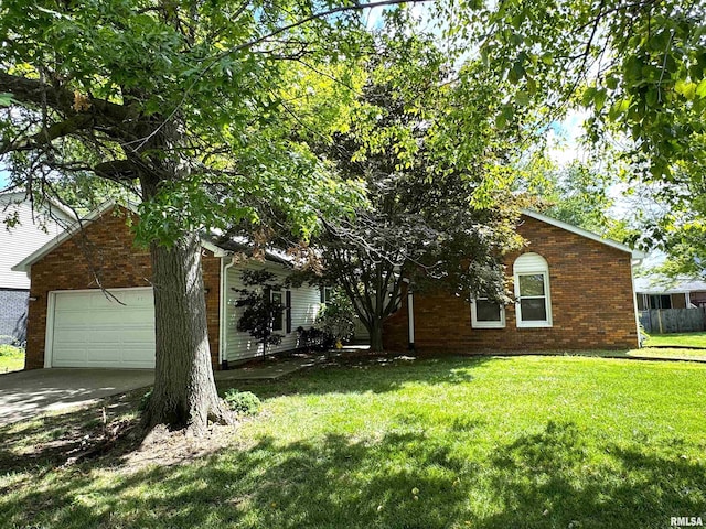 312 Astoria Rd, Springfield, IL 62704 - view of property hidden behind natural elements with brick siding, a front lawn, concrete driveway, and an attached garage