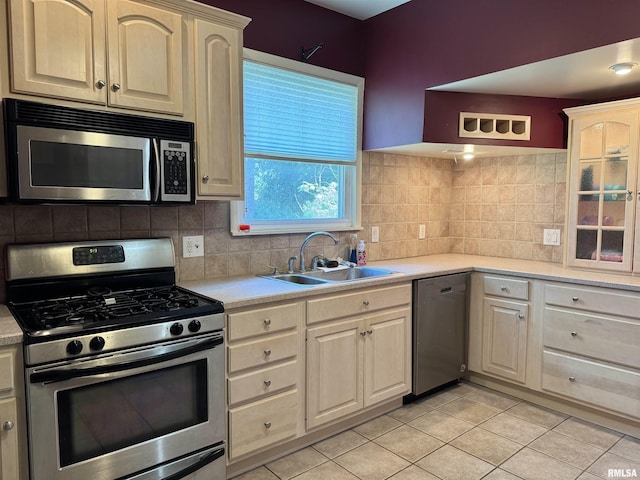 814 N Prairie St, Galesburg, IL 61401 - kitchen with appliances with stainless steel finishes, light countertops, light tile patterned floors, and backsplash