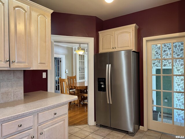 814 N Prairie St, Galesburg, IL 61401 - kitchen with stainless steel fridge with ice dispenser, light tile patterned flooring, light brown cabinets, light countertops, and decorative backsplash