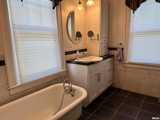 814 N Prairie St, Galesburg, IL 61401 - full bathroom with a soaking tub, tile walls, vanity, tile patterned flooring, and plenty of natural light