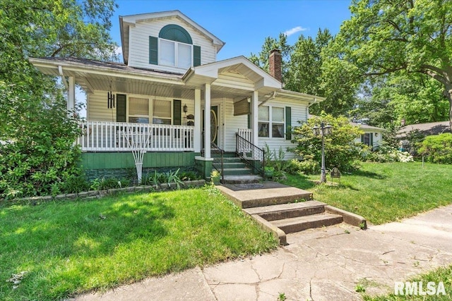 603 W Jefferson St, Auburn, IL 62615 - view of front of property with covered porch, a front yard, and a chimney