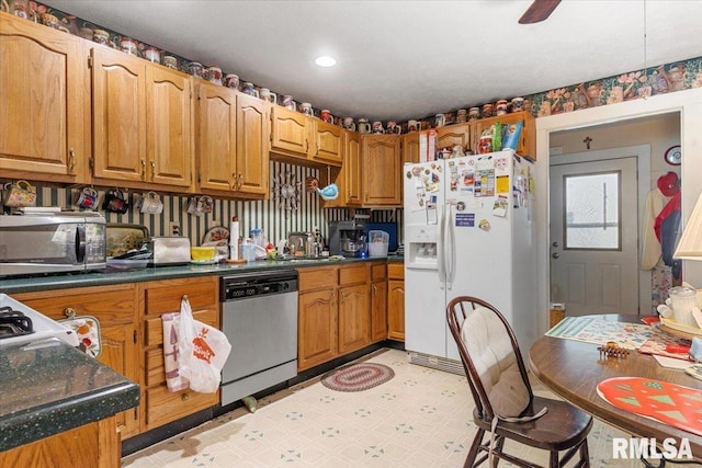 603 W Jefferson St, Auburn, IL 62615 - kitchen with stainless steel appliances, light floors, dark countertops, and brown cabinetry