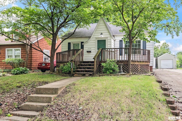 2535 S 8th St, Springfield, IL 62703 - view of front of property with a shingled roof, a wooden deck, an outdoor structure, a garage, and a front yard