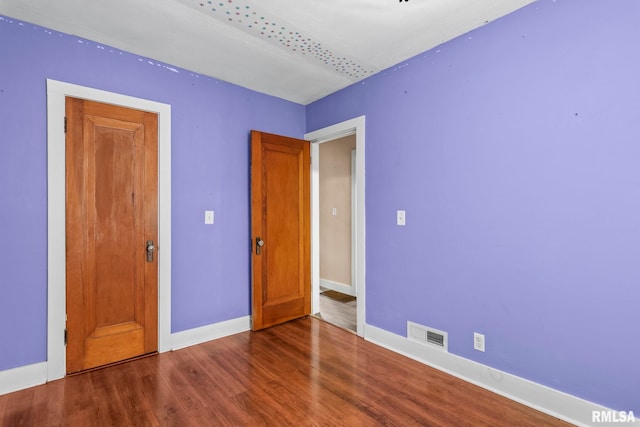 2535 S 8th St, Springfield, IL 62703 - unfurnished bedroom featuring baseboards and wood finished floors