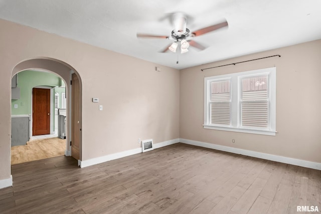 2535 S 8th St, Springfield, IL 62703 - empty room with ceiling fan, wood finished floors, and arched walkways
