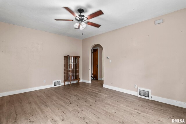 2535 S 8th St, Springfield, IL 62703 - unfurnished room with arched walkways, ceiling fan, and wood finished floors