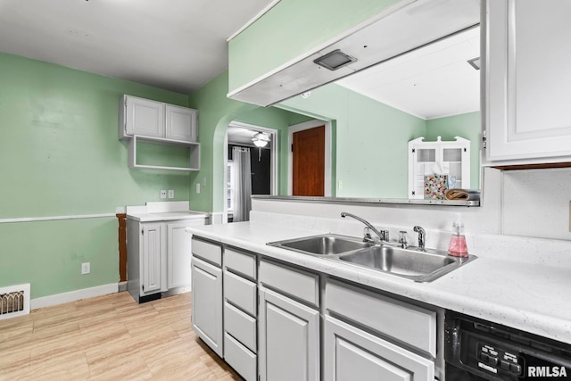 2535 S 8th St, Springfield, IL 62703 - kitchen with dishwasher, light countertops, white cabinetry, and arched walkways