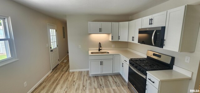 2217 Ramsey Ave, Springfield, IL 62702 - kitchen with stainless steel range with gas stovetop, light wood finished floors, and healthy amount of natural light