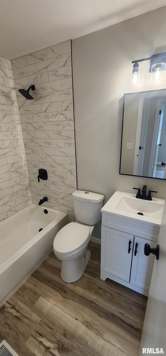2217 Ramsey Ave, Springfield, IL 62702 - bathroom featuring vanity, wood finished floors, and shower / washtub combination