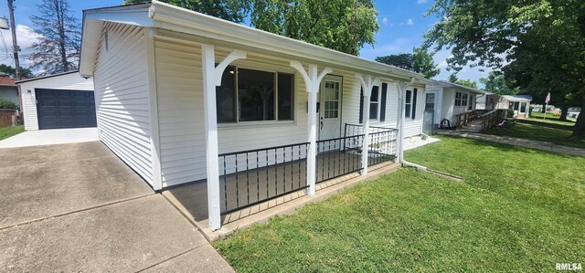 2217 Ramsey Ave, Springfield, IL 62702 - view of property exterior featuring a yard, a garage, an outbuilding, and covered porch