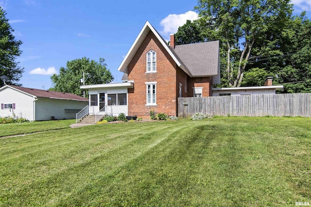 508 N Washington St, Mount Pulaski, IL 62548 - back of house featuring a sunroom, brick siding, and a chimney