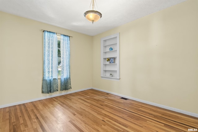 508 N Washington St, Mount Pulaski, IL 62548 - empty room with built in shelves and wood finished floors