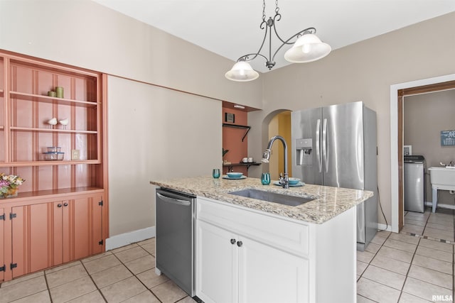 508 N Washington St, Mount Pulaski, IL 62548 - kitchen with light tile patterned floors, stainless steel appliances, an island with sink, and arched walkways