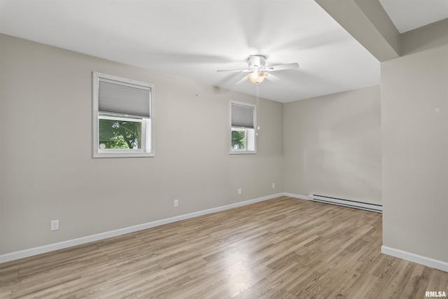 508 N Washington St, Mount Pulaski, IL 62548 - empty room featuring baseboard heating, a ceiling fan, and light wood-style flooring