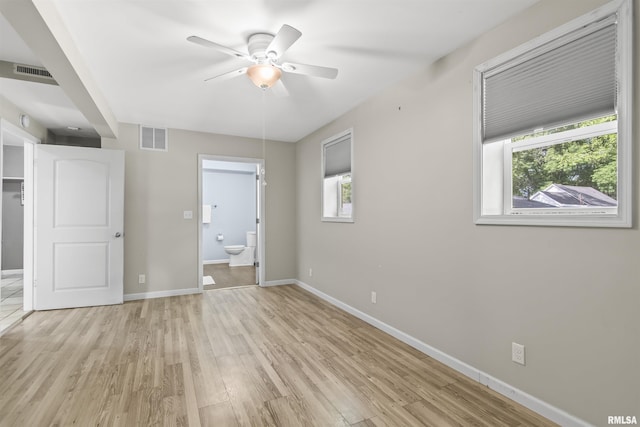 508 N Washington St, Mount Pulaski, IL 62548 - unfurnished bedroom with light wood finished floors, ensuite bathroom, and ceiling fan