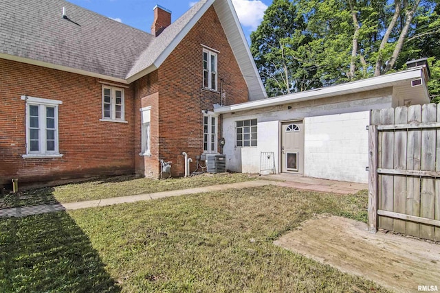 508 N Washington St, Mount Pulaski, IL 62548 - rear view of property featuring roof with shingles, a chimney, and brick siding