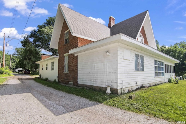 508 N Washington St, Mount Pulaski, IL 62548 - view of property exterior featuring a shingled roof, a chimney, dirt driveway, and brick siding