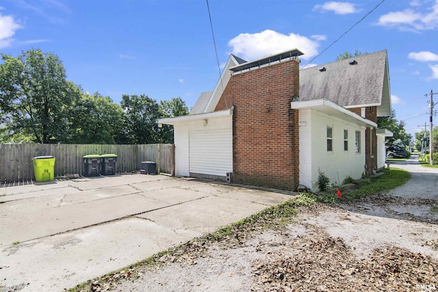 508 N Washington St, Mount Pulaski, IL 62548 - view of home's exterior featuring a shingled roof and a chimney