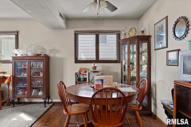 102 W Scarritt St, Springfield, IL 62704 - dining room featuring a ceiling fan, dark wood-type flooring, plenty of natural light, and a textured ceiling
