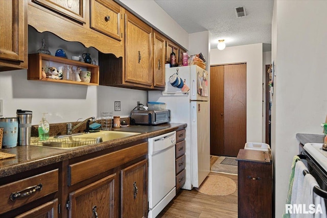 102 W Scarritt St, Springfield, IL 62704 - kitchen featuring white appliances, dark countertops, wood finished floors, open shelves, and a textured ceiling