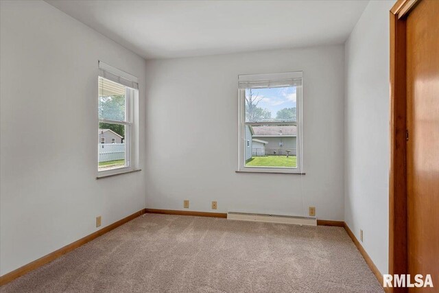 1640 W Glenn Ave, Springfield, IL 62704 - carpeted empty room featuring a baseboard heating unit and baseboards