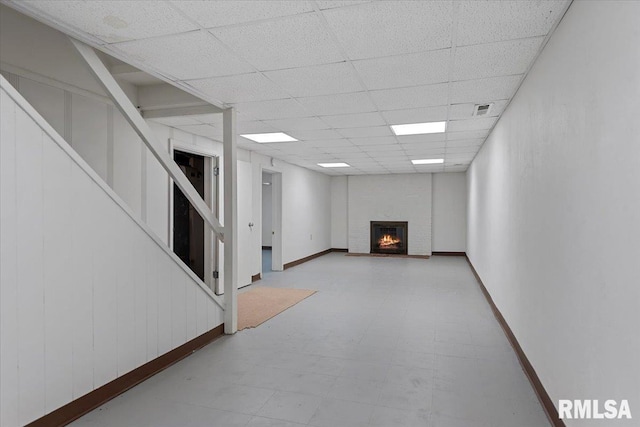 1640 W Glenn Ave, Springfield, IL 62704 - below grade area with stairway, a paneled ceiling, tile patterned floors, and a brick fireplace