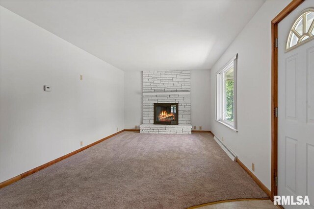 1640 W Glenn Ave, Springfield, IL 62704 - unfurnished living room featuring a baseboard radiator, carpet floors, and a stone fireplace