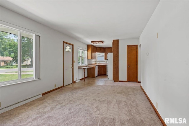 1640 W Glenn Ave, Springfield, IL 62704 - unfurnished living room featuring a baseboard radiator and light colored carpet